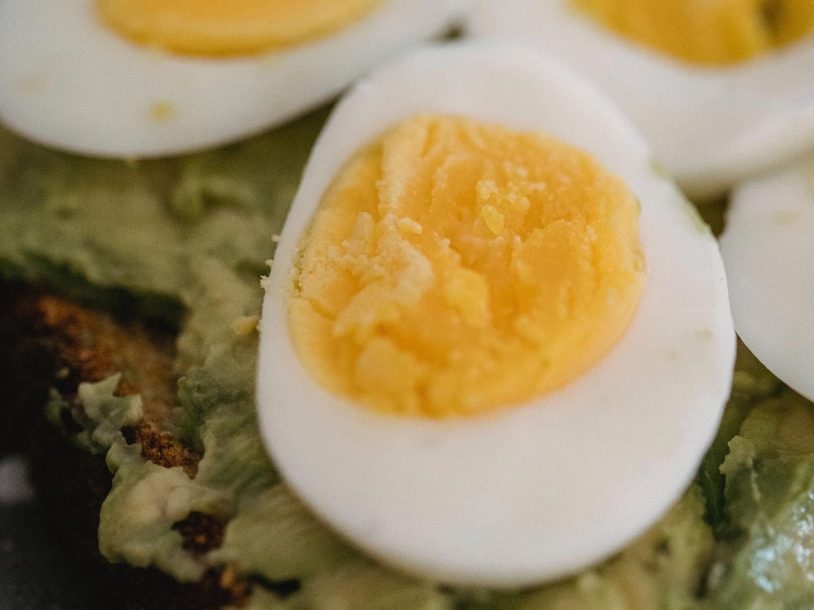 Toast topped with sliced avocado and egg.