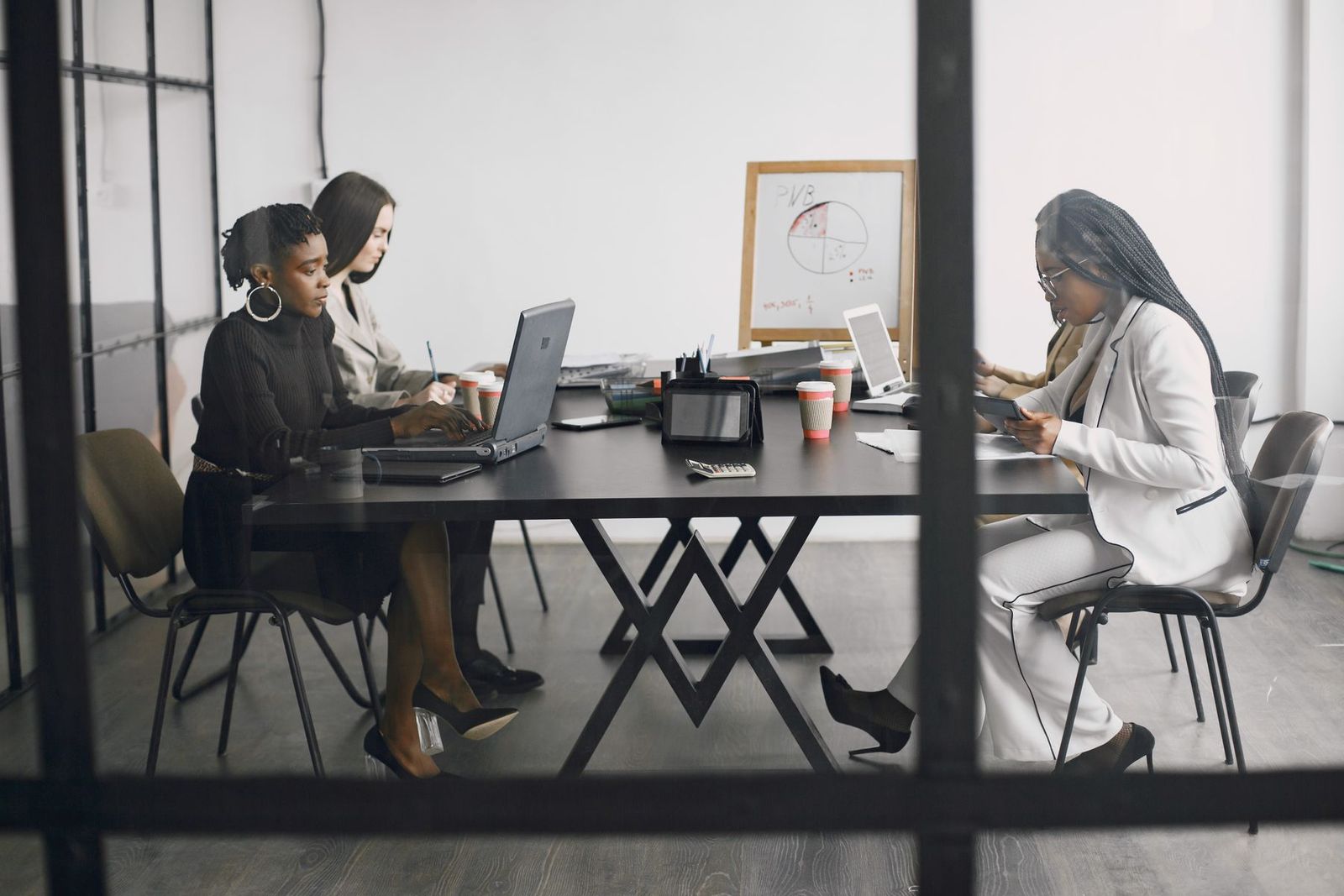 Women seated around an office meeting table.