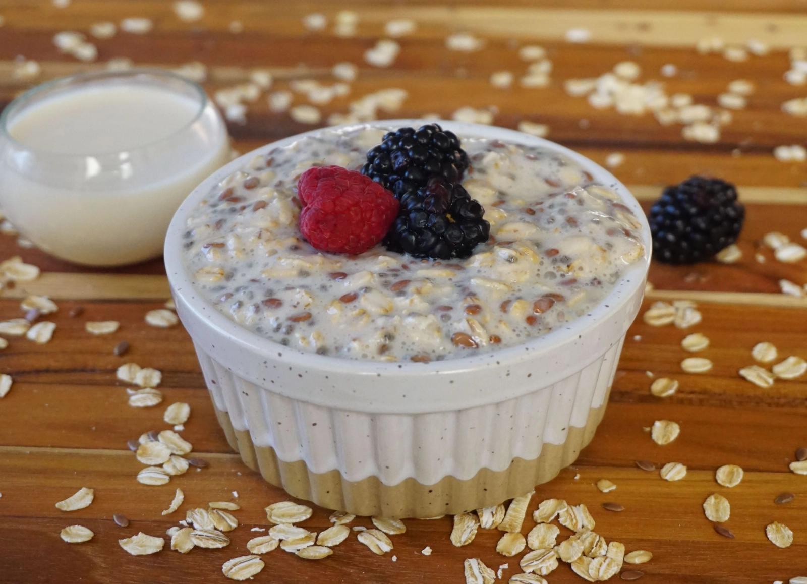 Oats topped with berries in a white bowl.