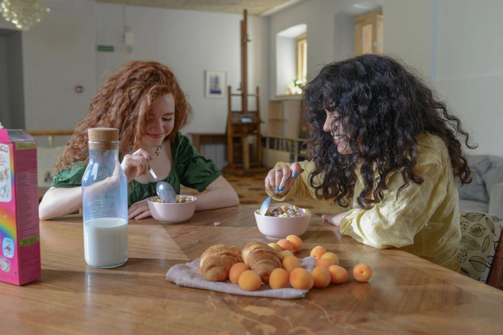Two women having breakfast together at a table.