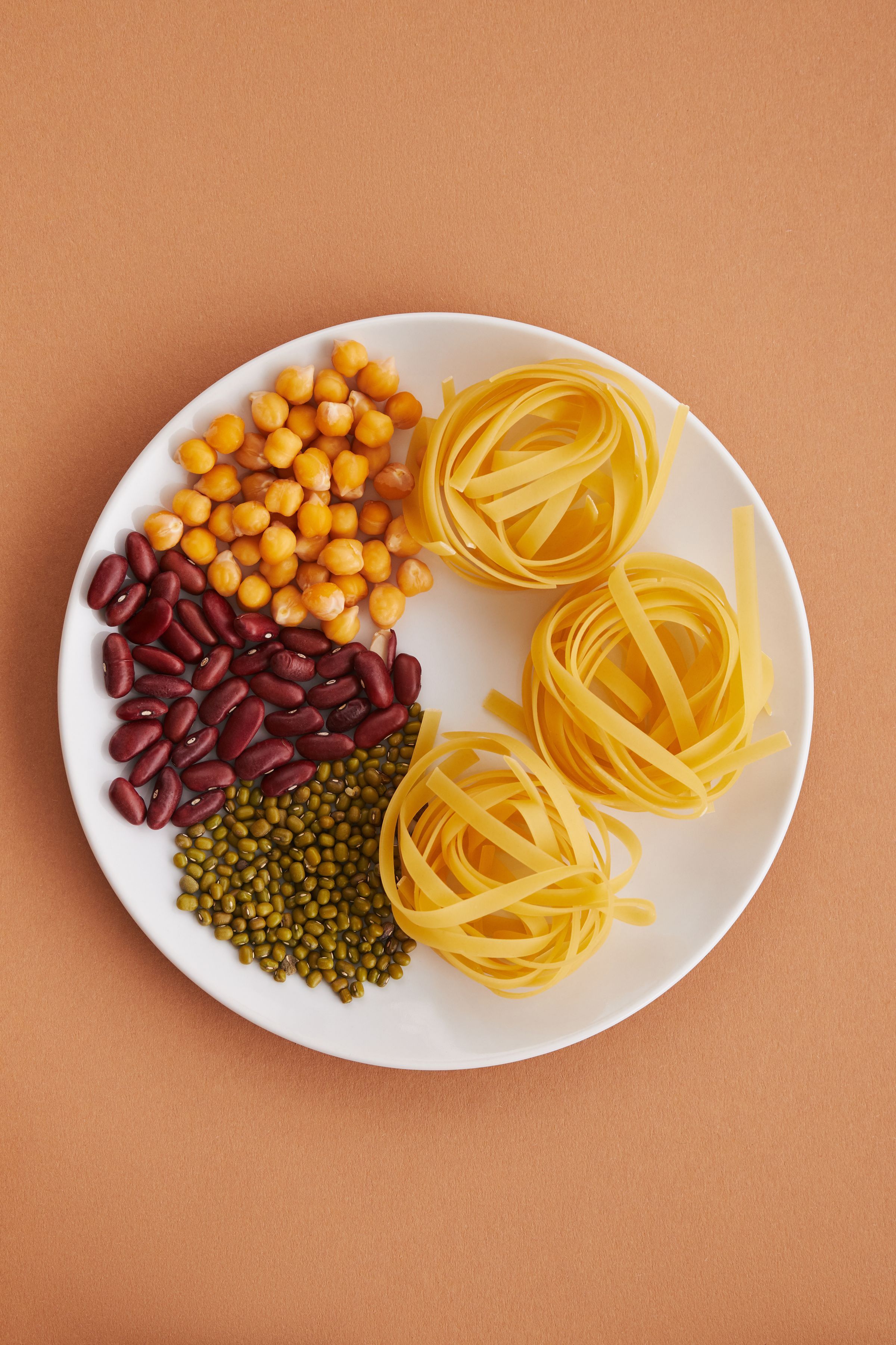 Pasta and pulses arranged on a plate.