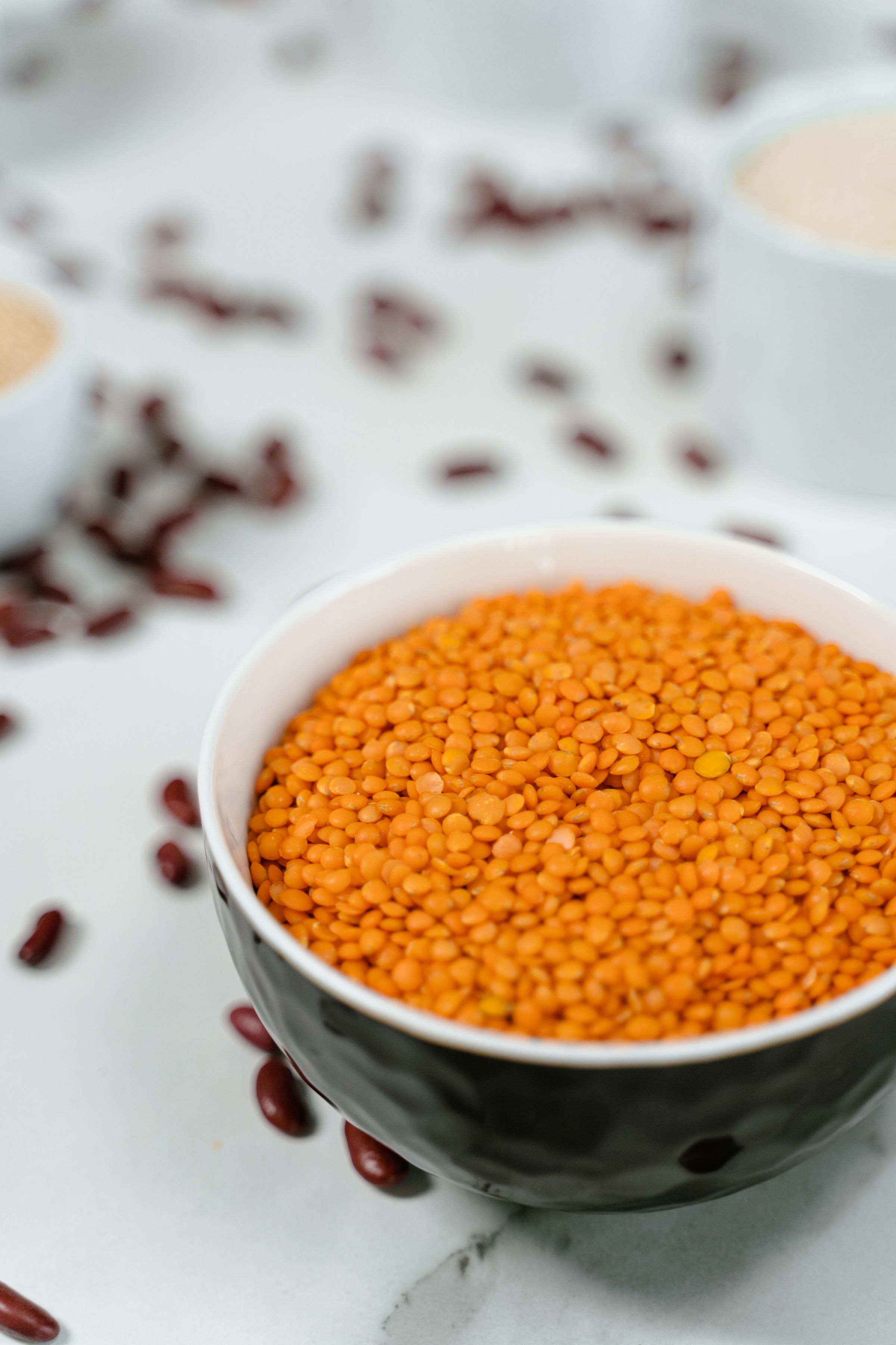 Red lentils in a ceramic bowl.