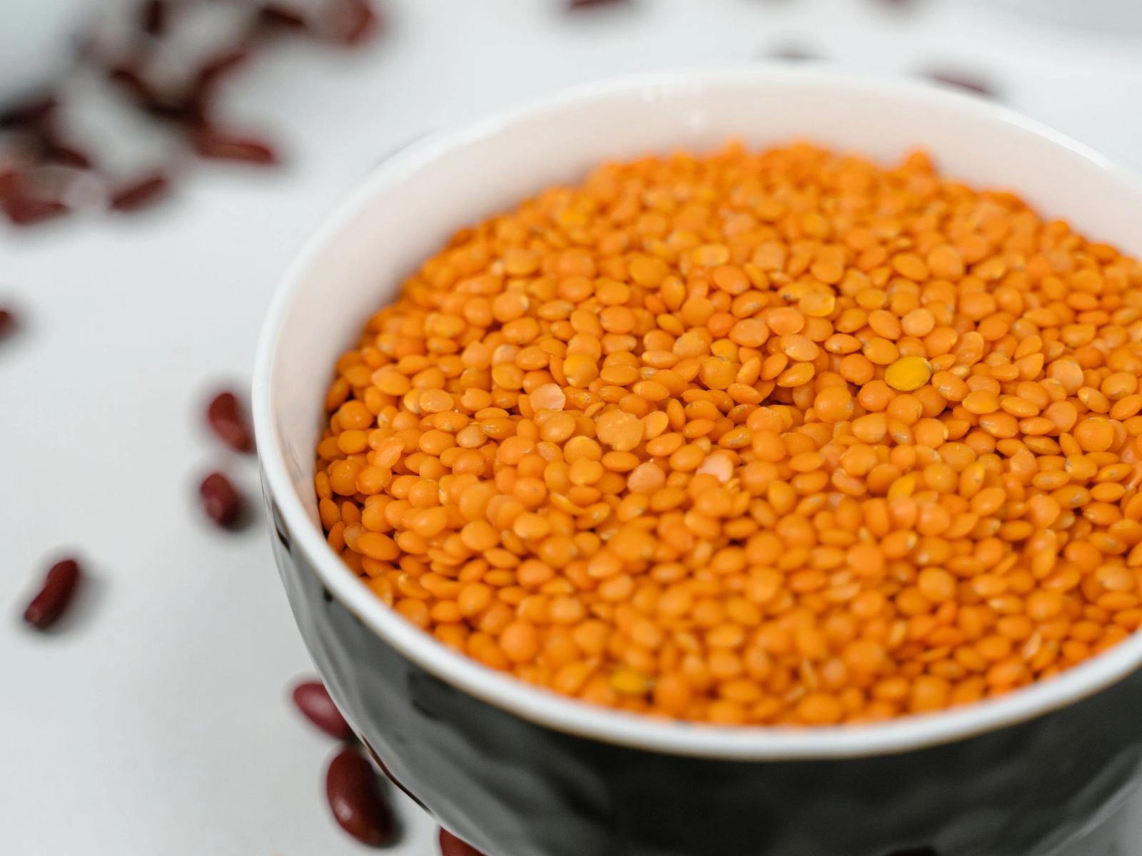 Red lentils in a ceramic bowl.