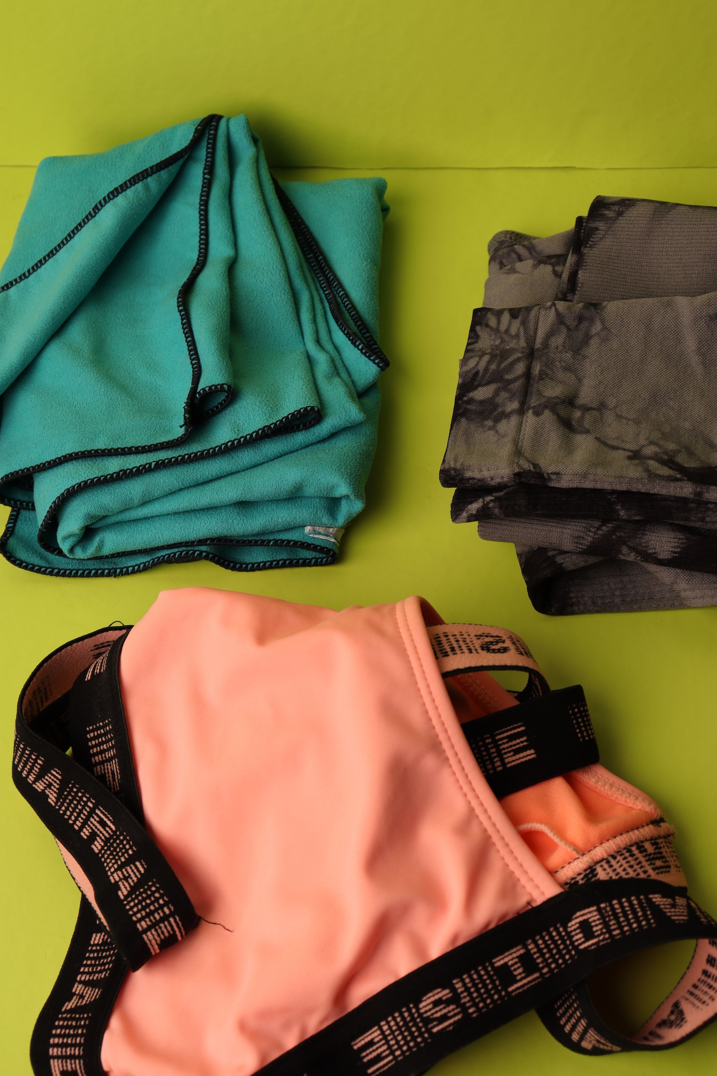 Colorful underwear arranged on green fabric.