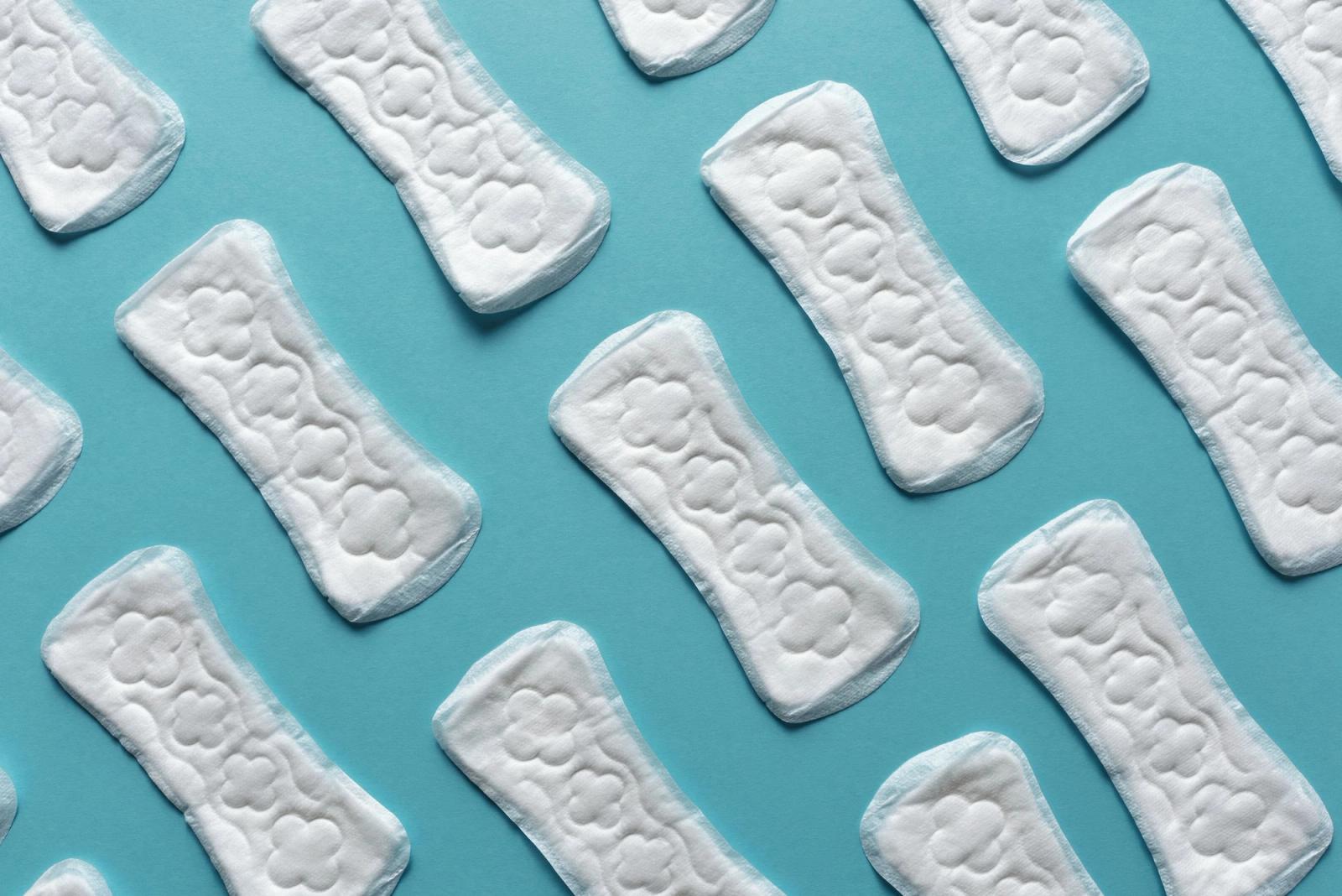 White sanitary pads arranged on a blue background.