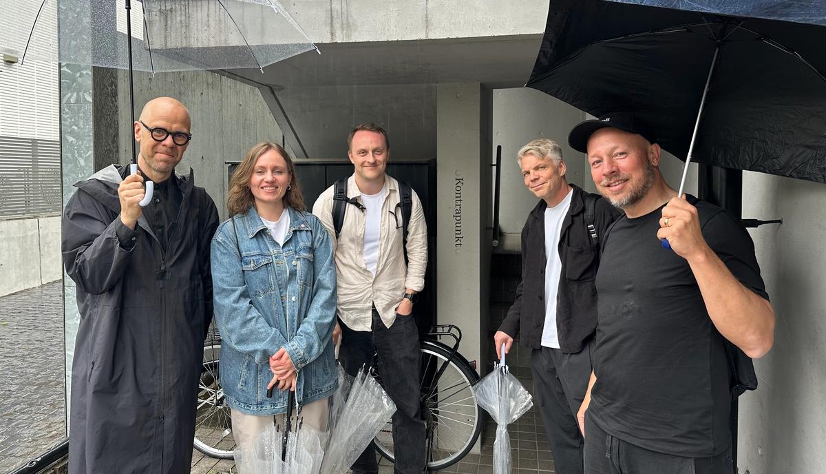 Members of the Plan8 team standing together in Tokyo.