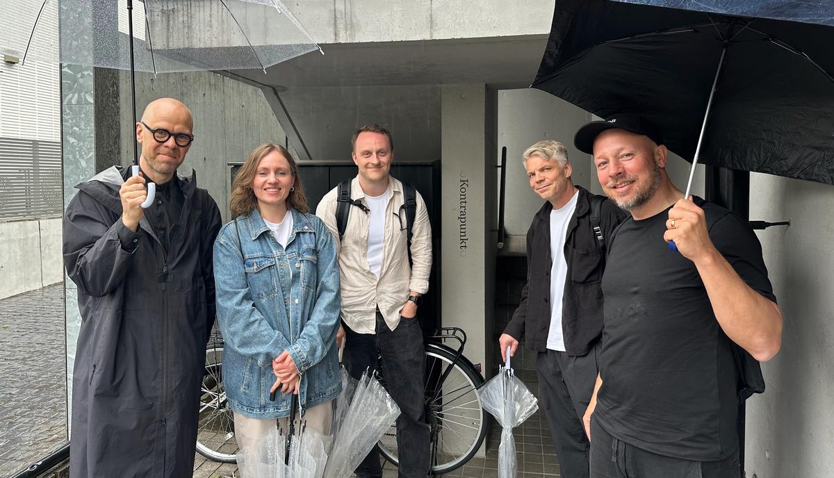 Members of the Plan8 team standing together in Tokyo.