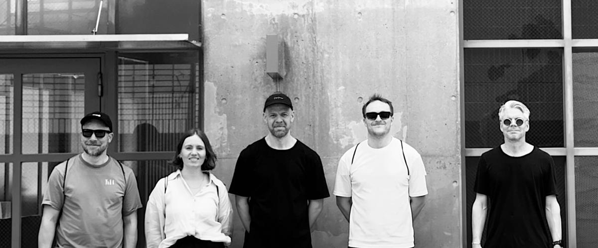 Plan8 team standing infront of a building in Tokyo 