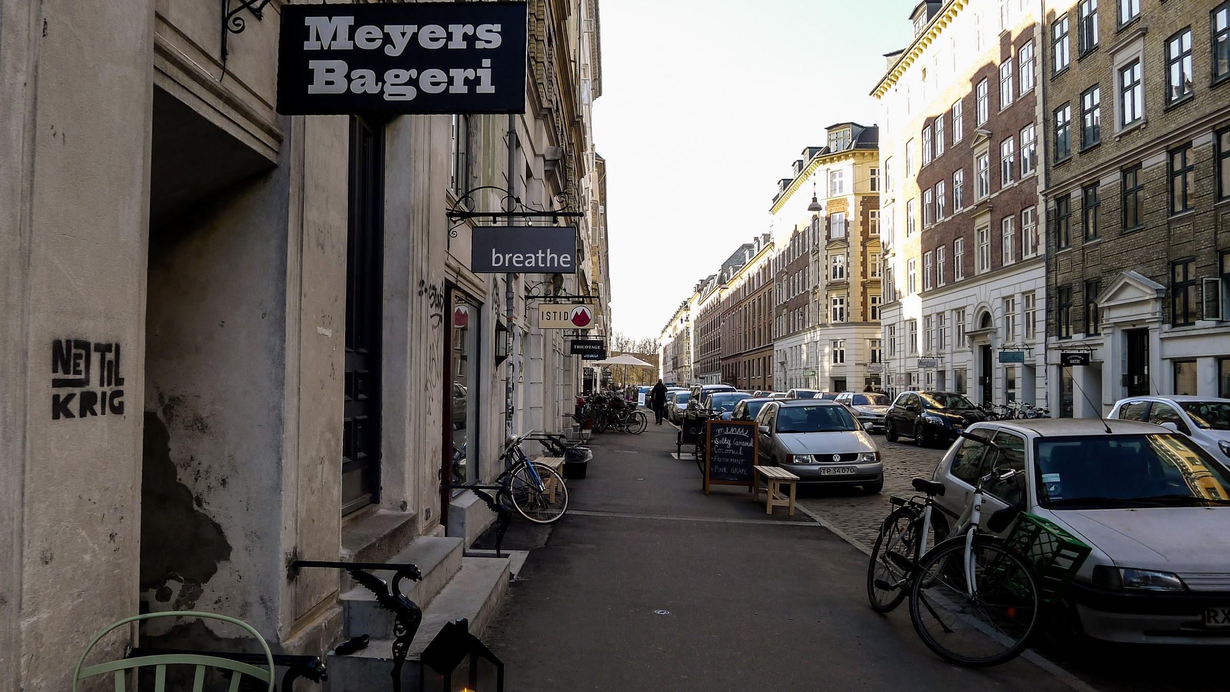 Shopfronts, bicycles and residents on Jægersborggade