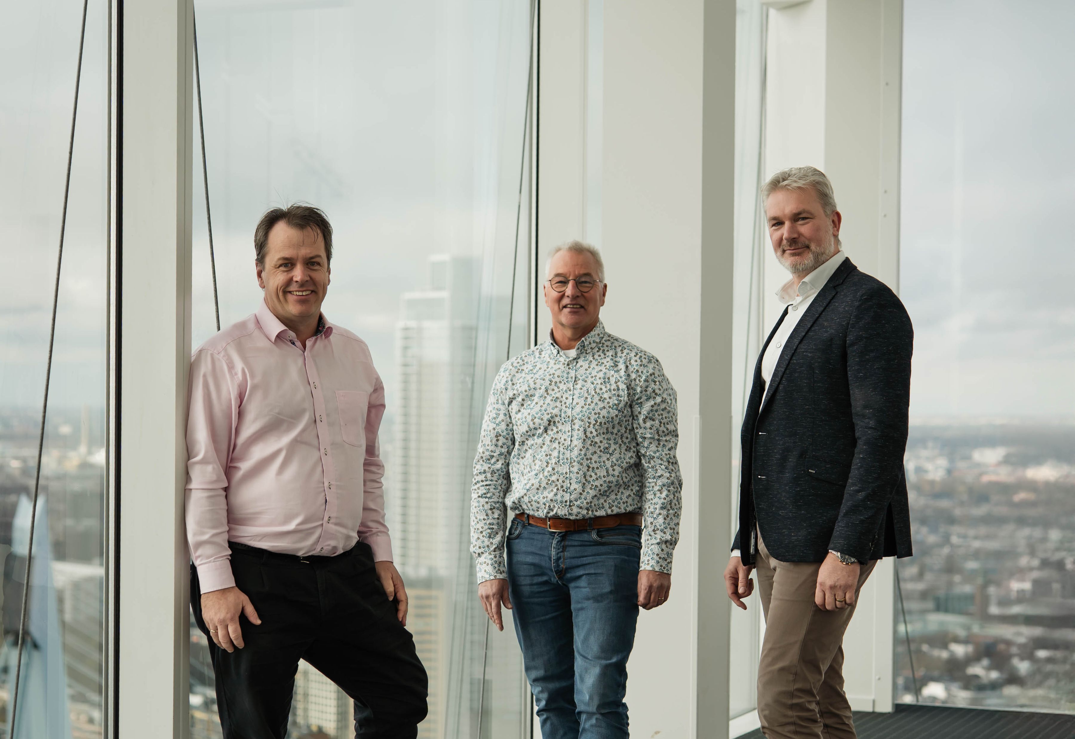 Pieter, Rien and Menno in a high tower building overlooking Rotterdam