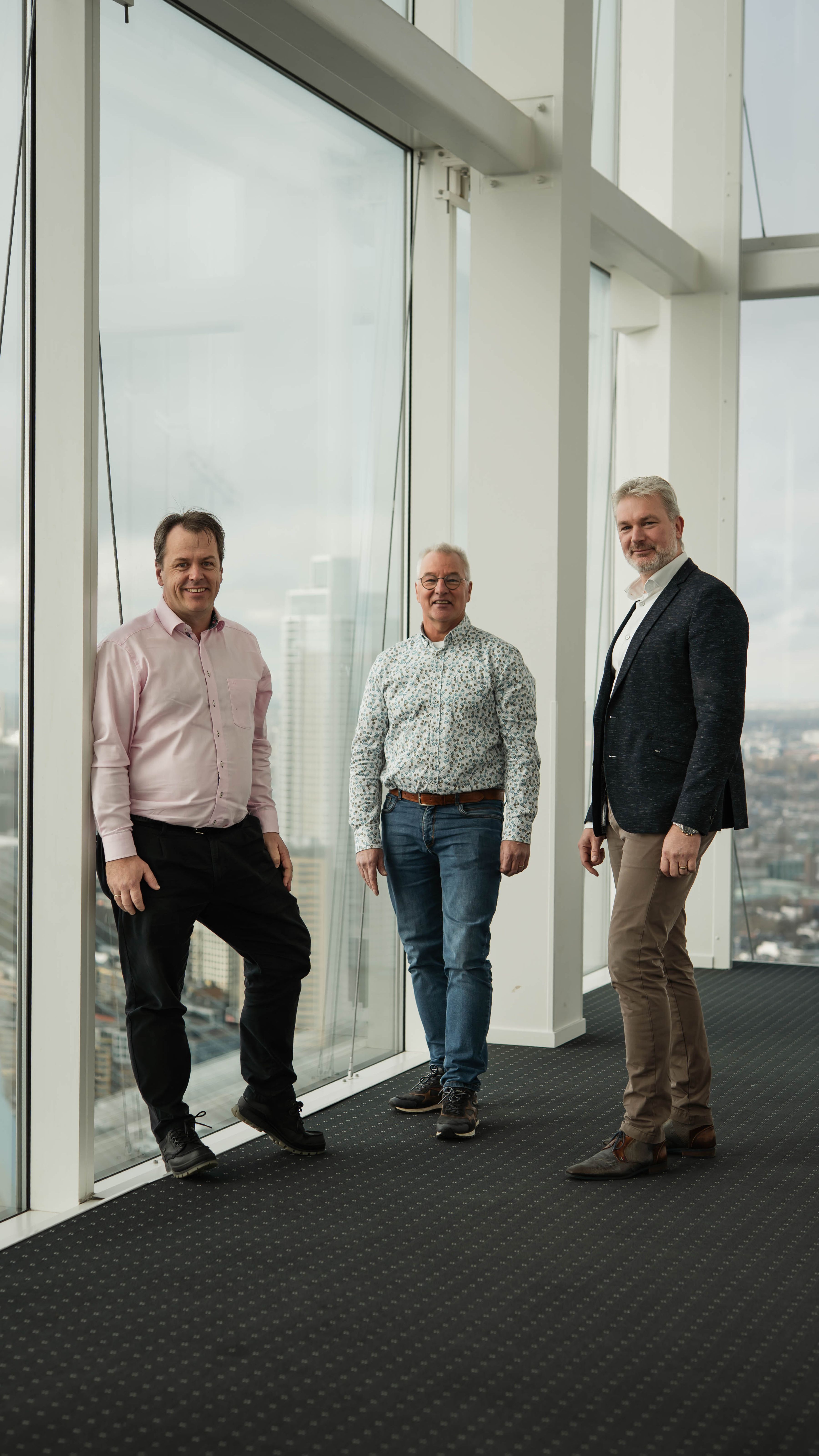 Pieter, Rien and Menno in a high tower building overlooking Rotterdam