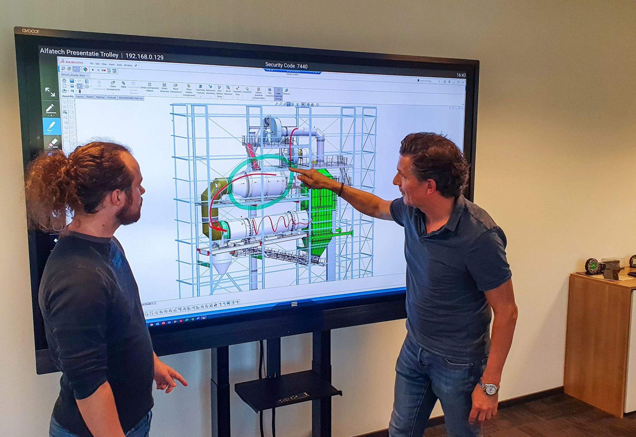 Colleagues study a design of a asphalt machine