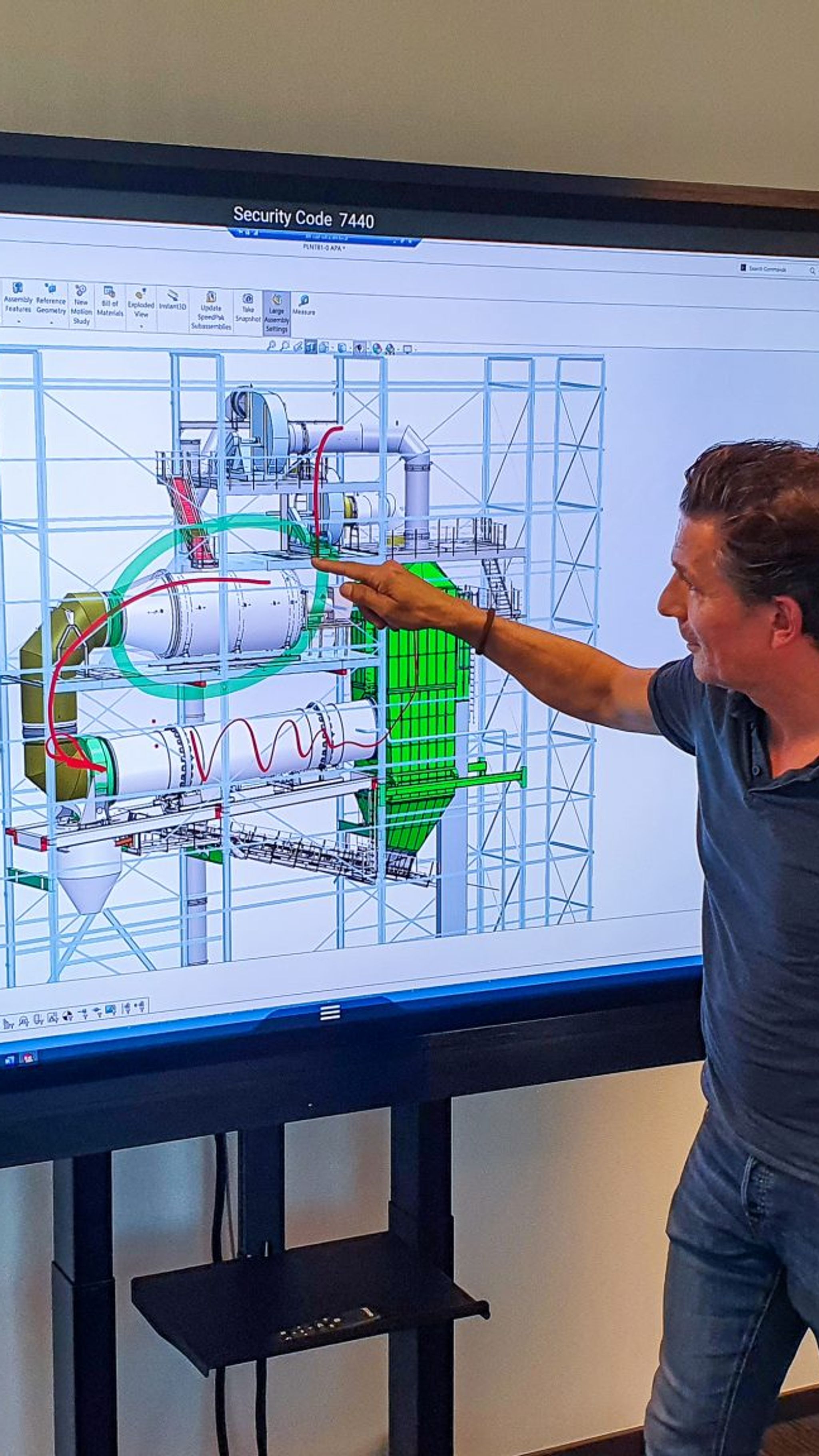 Colleagues study a design of a asphalt machine