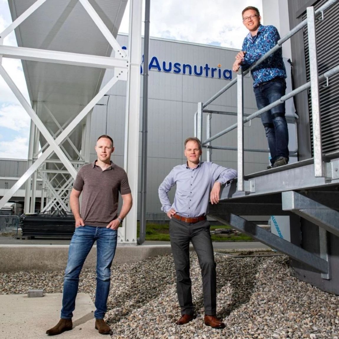 Drie mannen voor het Ausnutria-logo