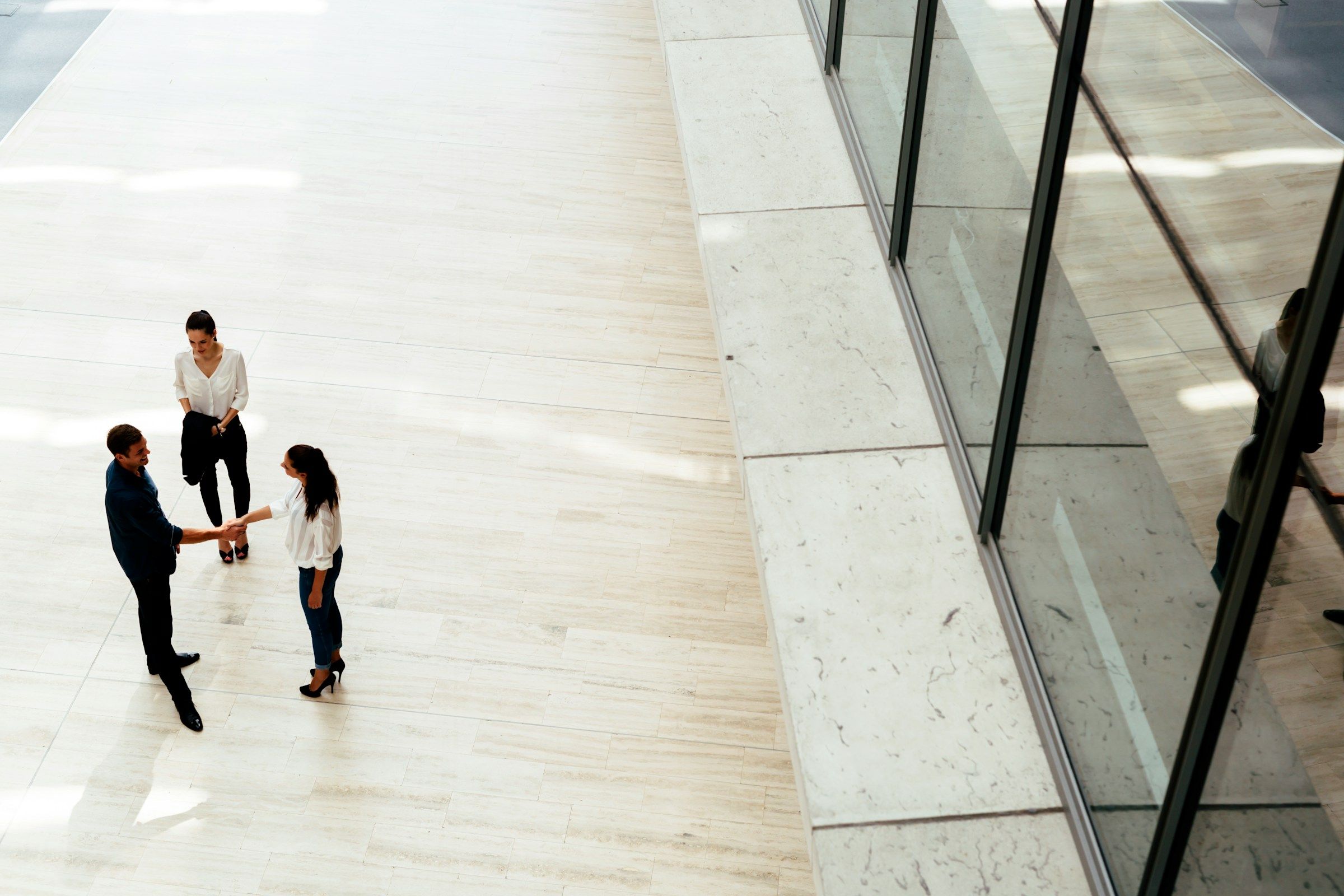 Corporate building with people discussing