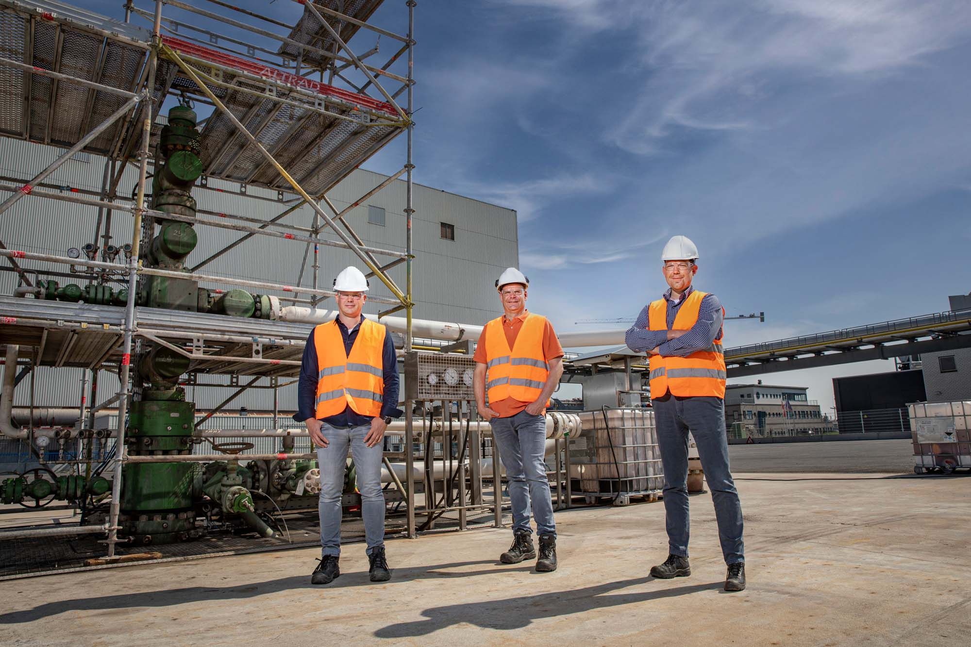 Men standing in front of factory