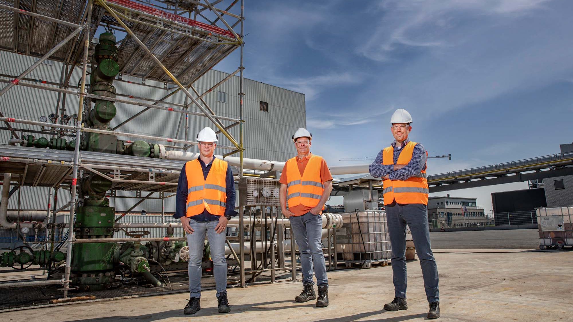 Men standing in front of factory