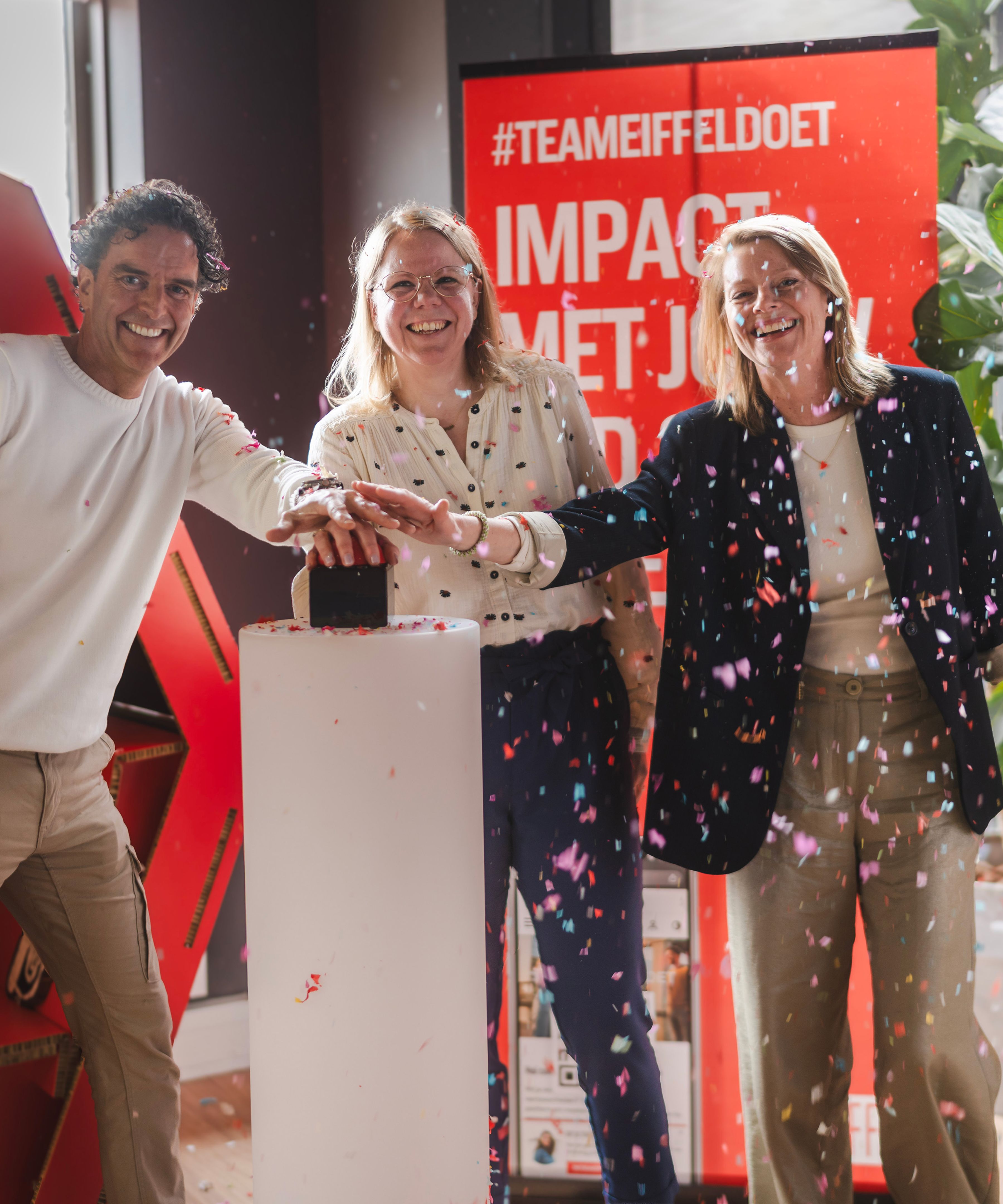 Three EIFFEL colleagues press a button to launch the social impact platform