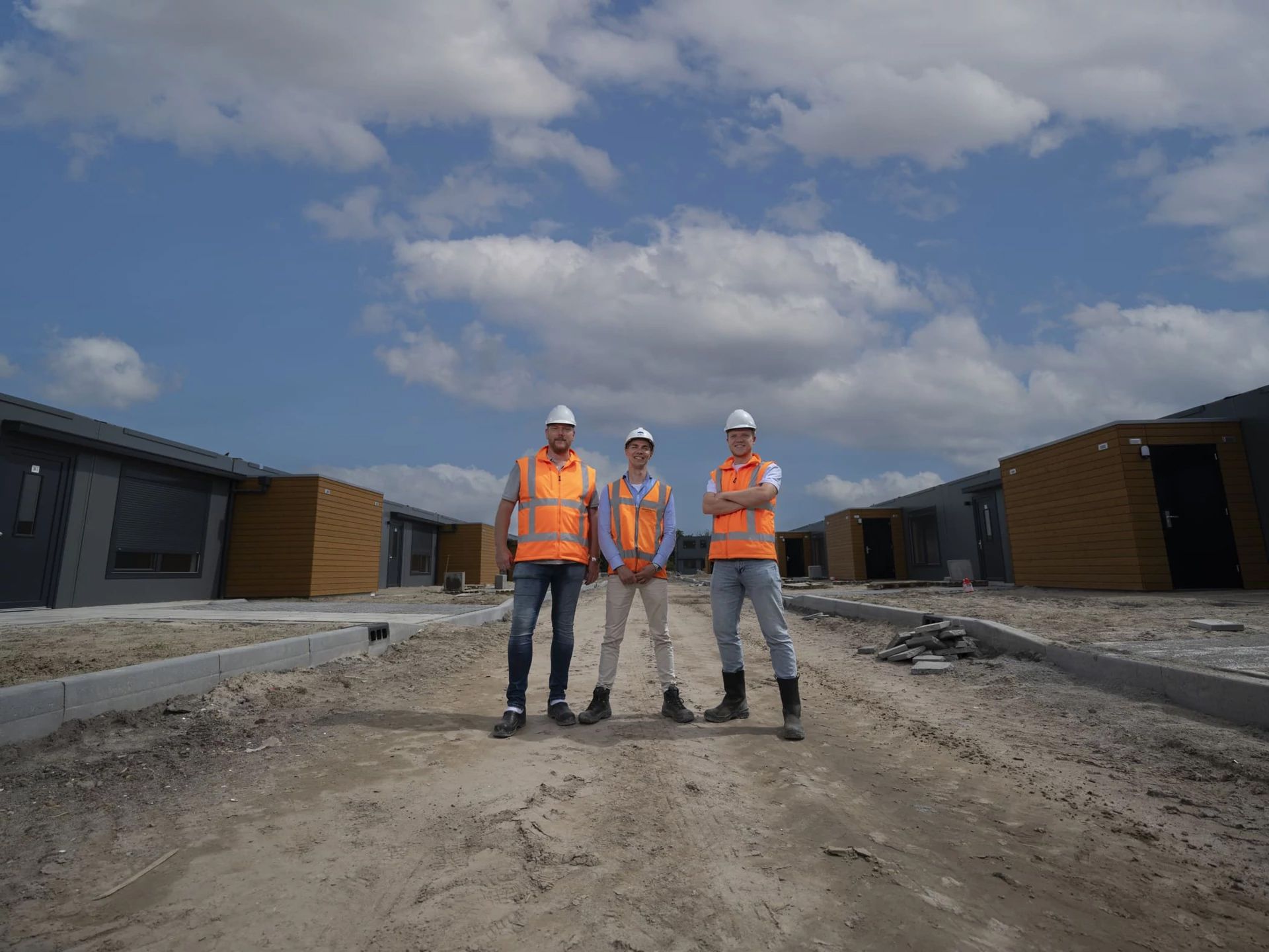 Three men in construction outfits on a construction site