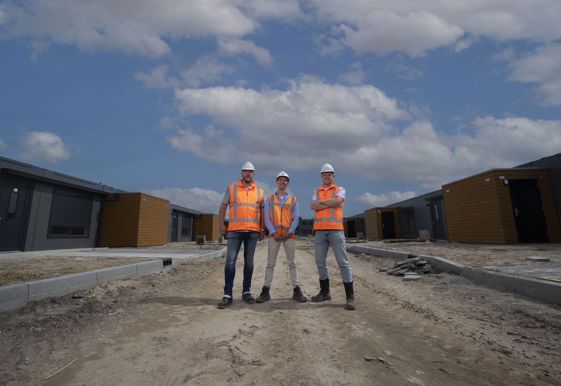 Three men in construction outfits on a construction site