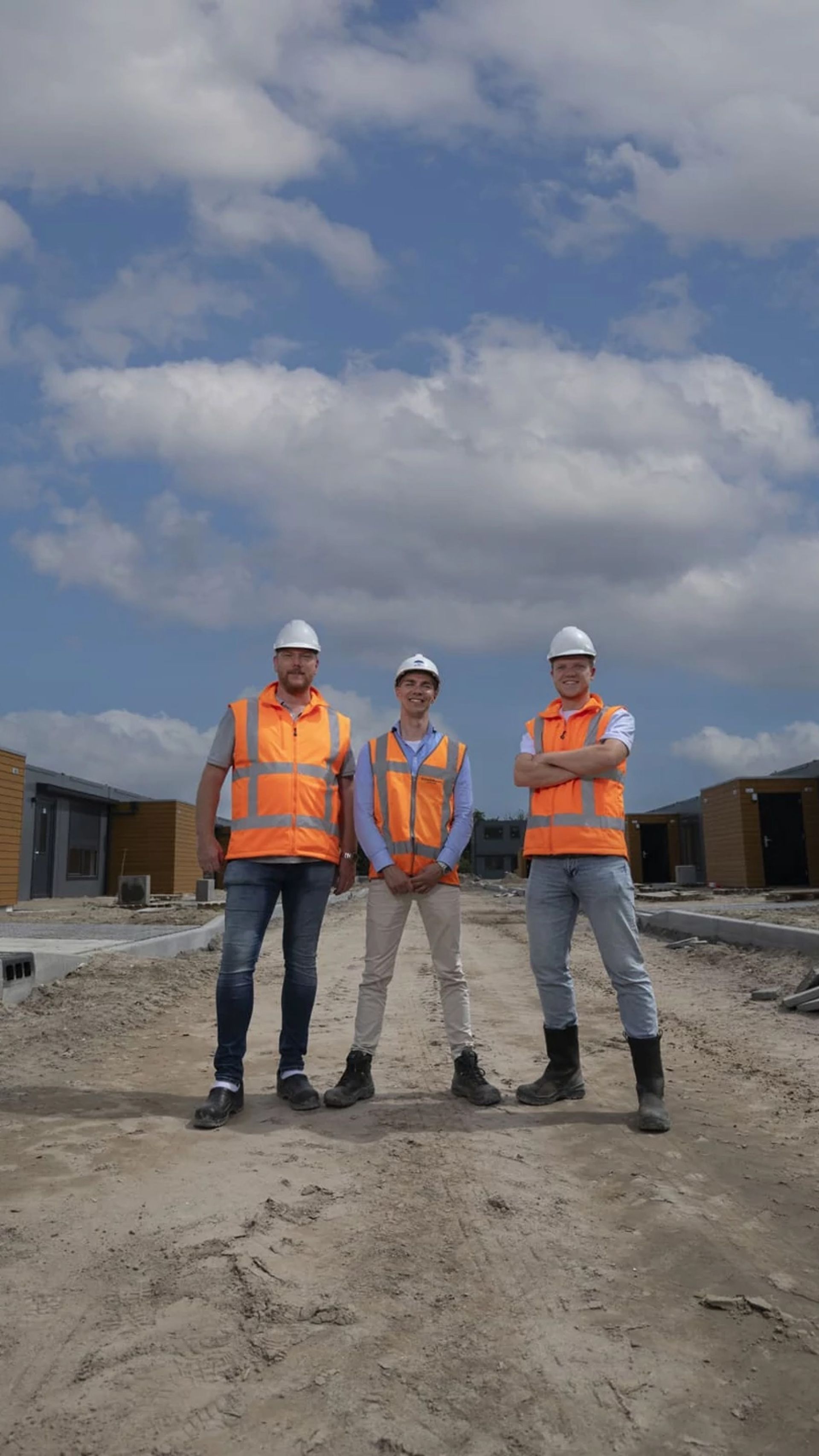 Three men in construction outfits on a construction site