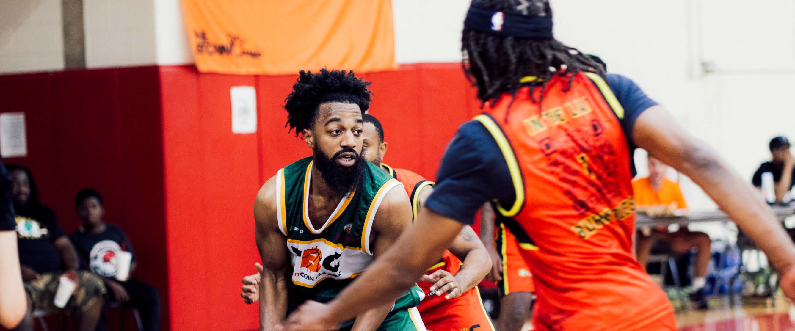 A group of men playing basketball at The Bitcoin Classic tournament. 