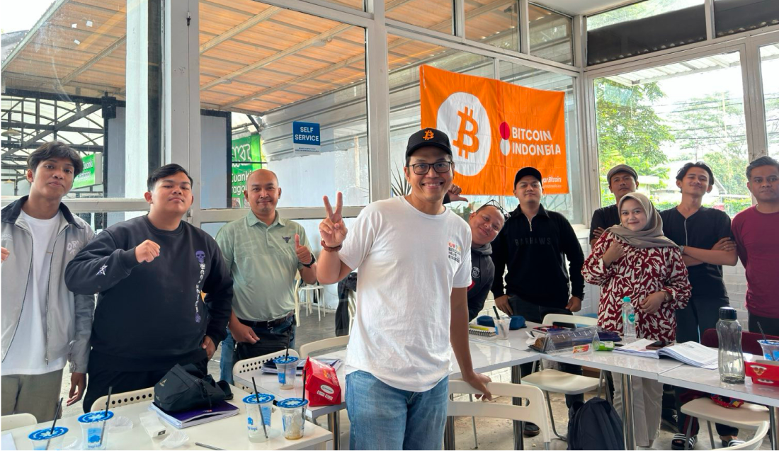 A group of people pose for a picture in a classroom.