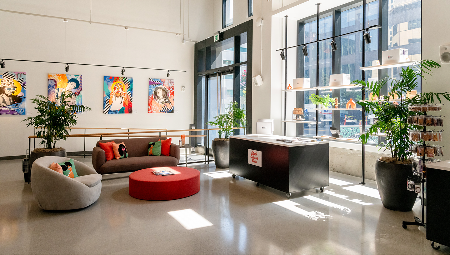interior photo of block community hub with art on the wall and seating area 