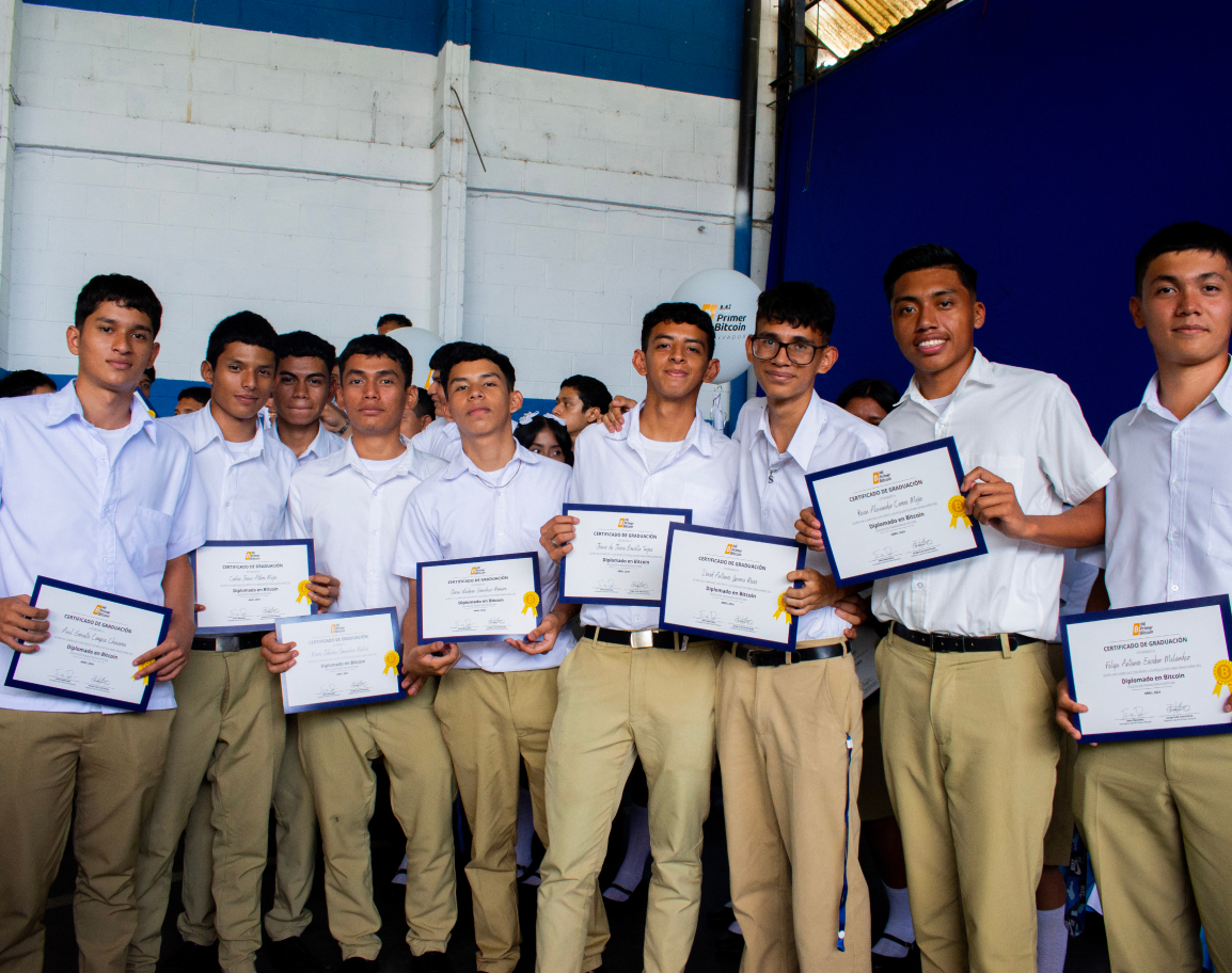 A group of children stand holding certificates.