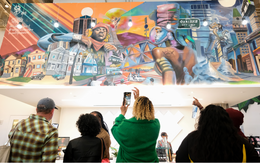 Picture of a group of people viewing a mural.