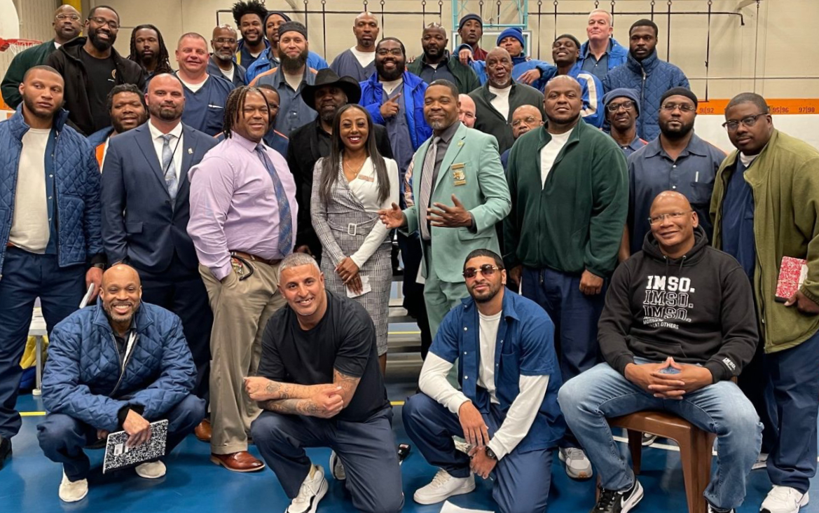 A group of adults smile and pose for a photograph.