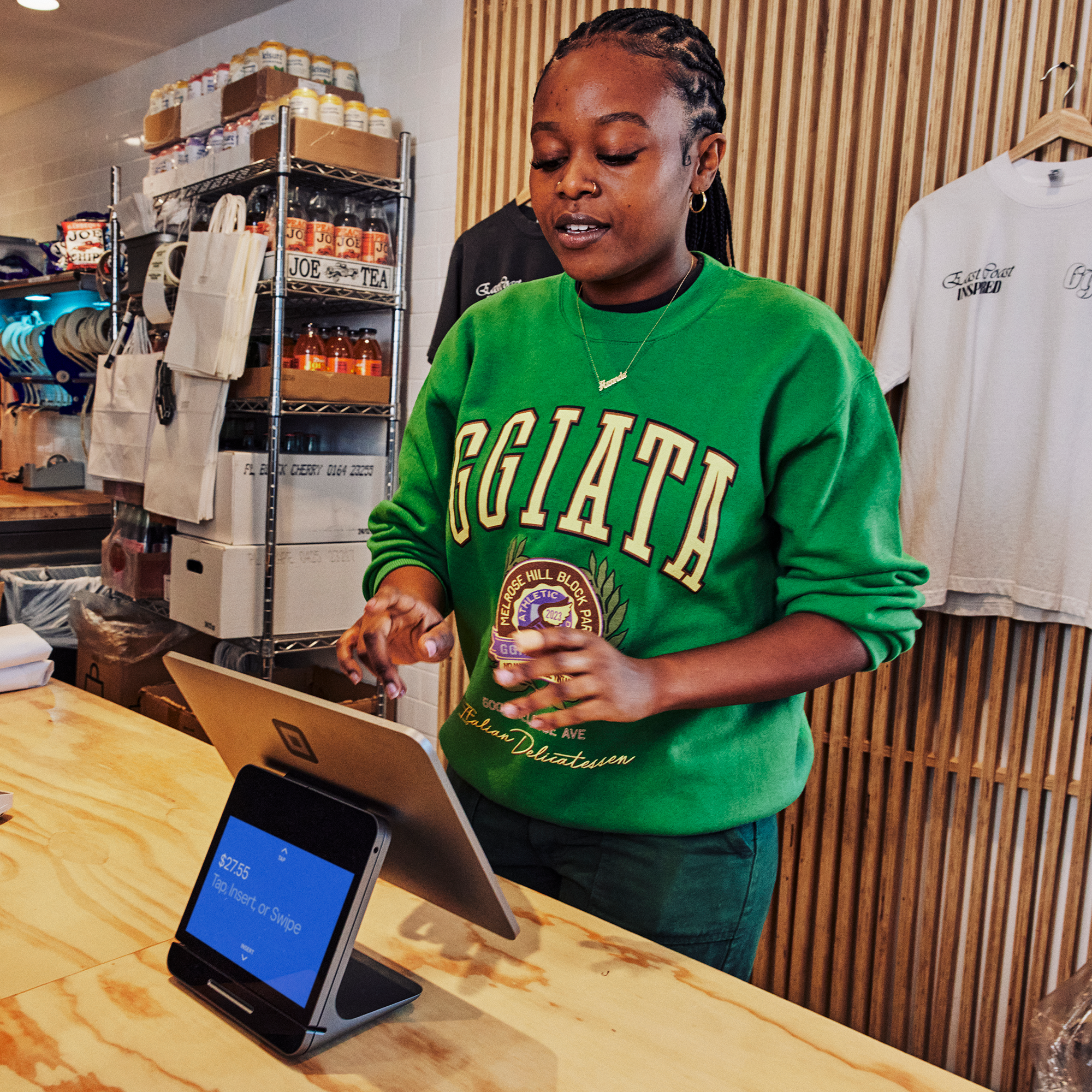 A cashier using a Square Stand register.