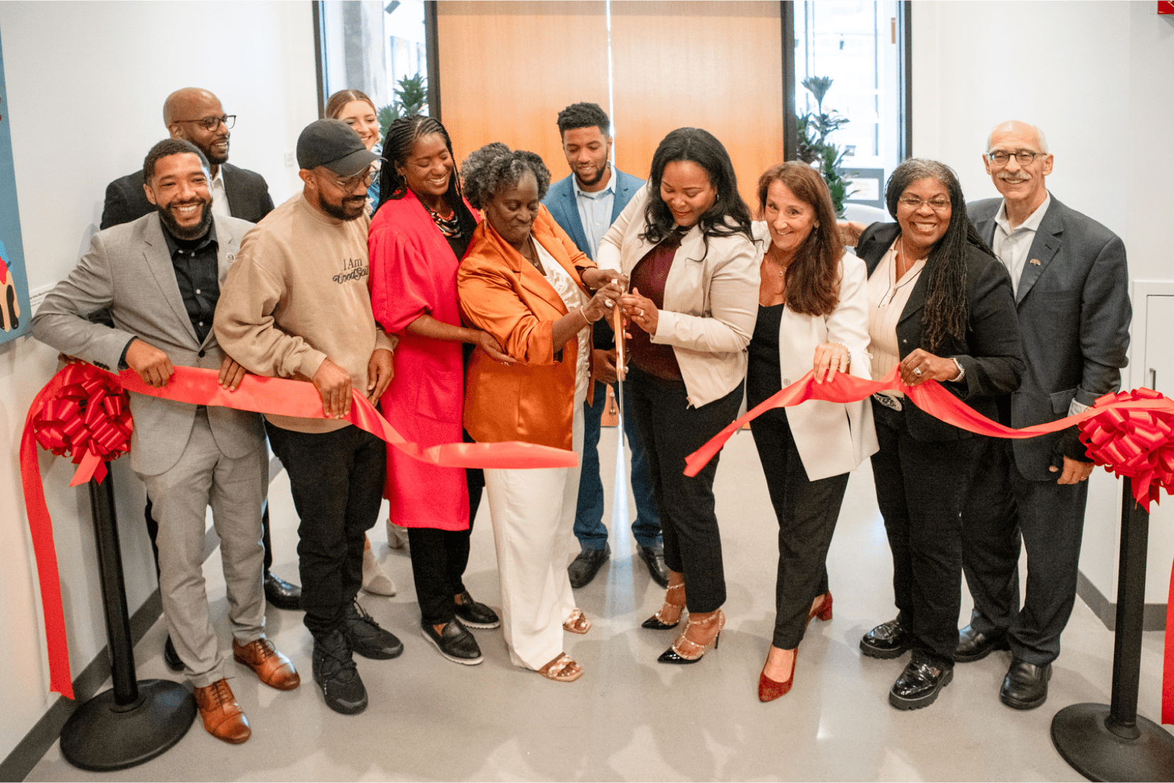 Cutting the ribbon to officially open Uptown Market to the public.