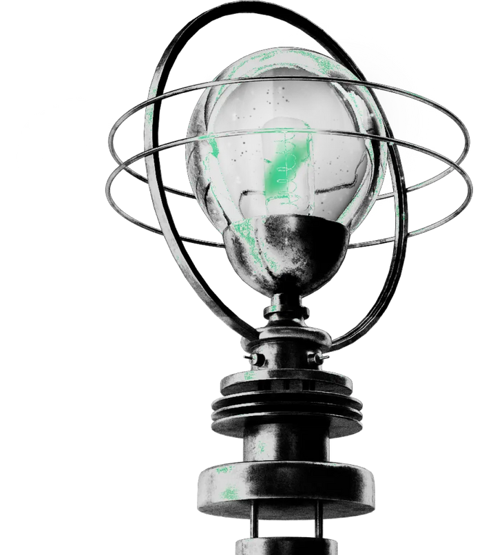 Srebrna lampa z zielonymi elementami w stylu Kryptonum jako symbol kreatywnych pomysłów, które ma agencja kreatywna Kryptonum