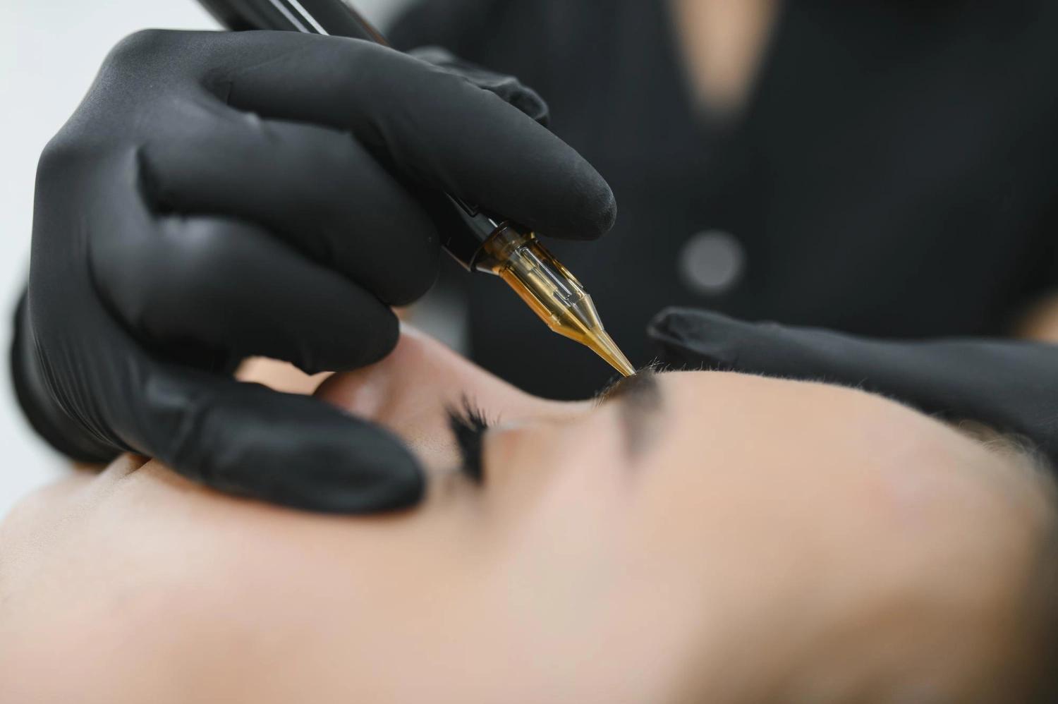 Close-up of non-laser permanent makeup removal on eyebrow in Berlin using professional tattoo machine