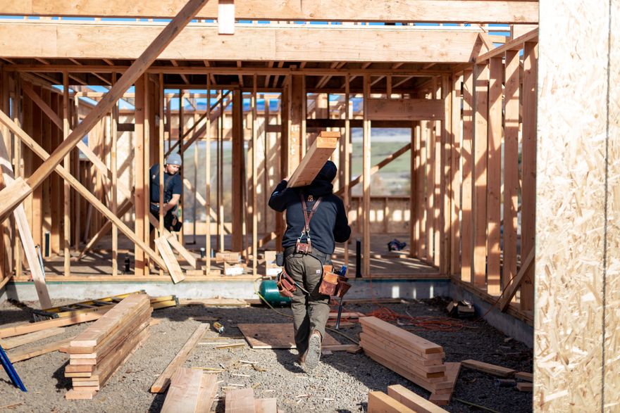 A framing crew building the walls of a new wood-frame home.