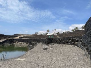 View of the seated area at Piscina Natural Coloseo