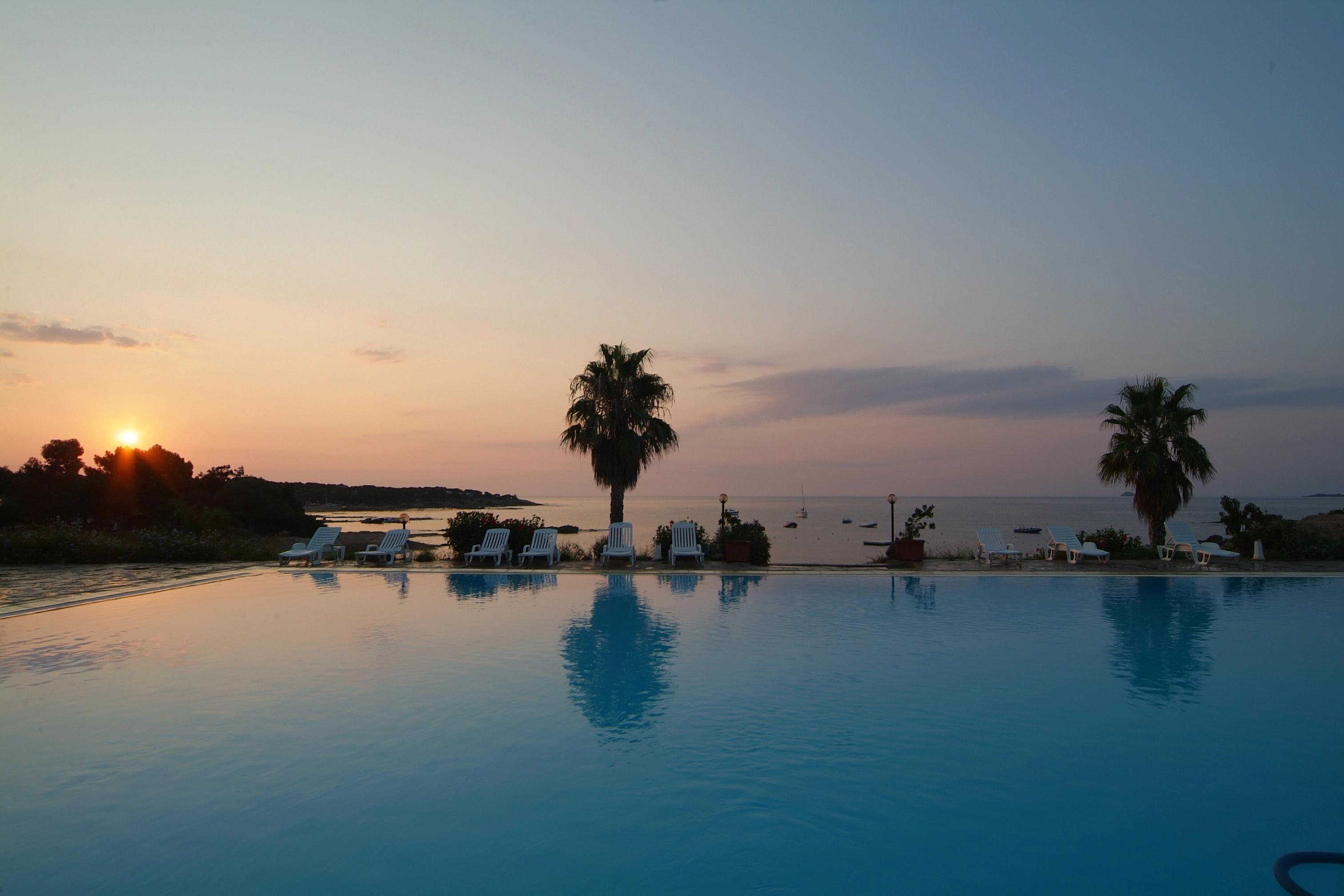 Swimming pool at sunset - La Chiappa Village Naturiste, Corsica