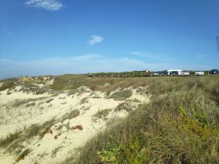 The dirt car park is right above the beach at Praia das Pedras Negras