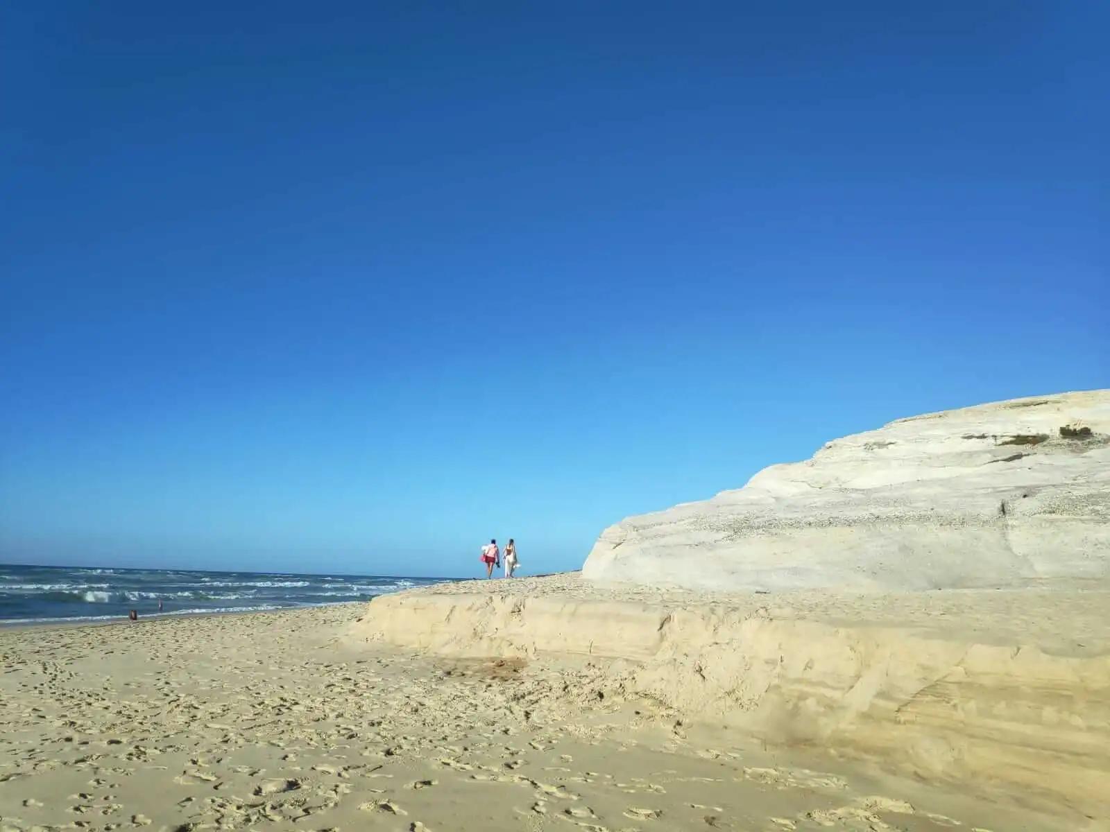 Layered sand and rocks to lie on at Praia do Rei Cortiço