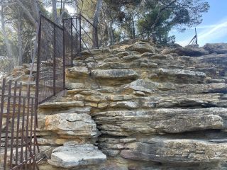 Climbing this ledge to access the naturist section is tricky but easier than it looks. Plage du Liouquet.