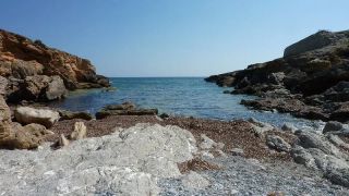 Areas of rocks between the sand at Cala Estreta