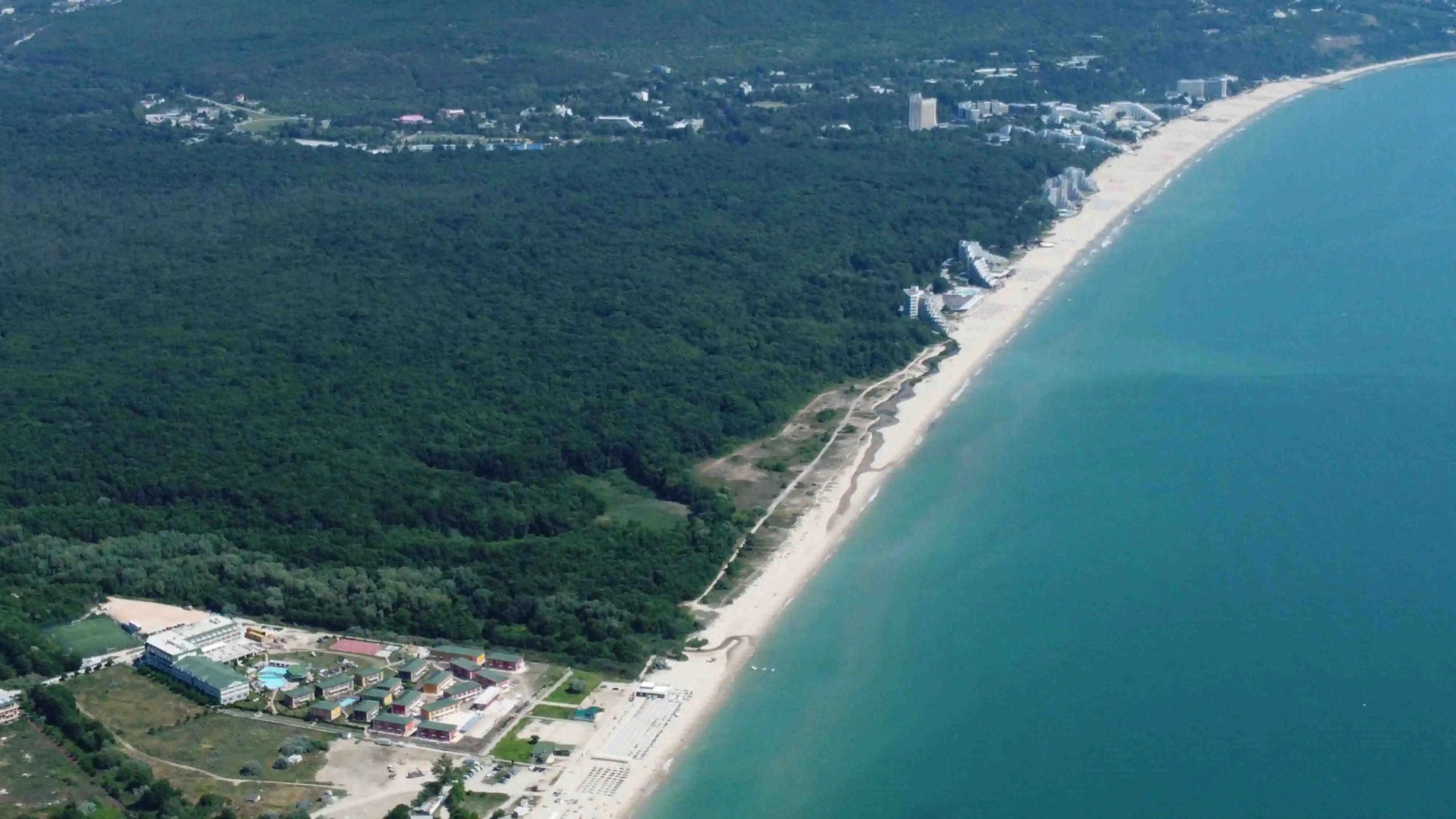 The nude beach is located shortly after crossing the small river between resorts