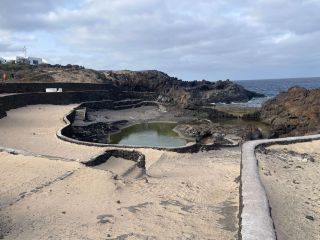 View of the ocean and pool from the sandy sitting area