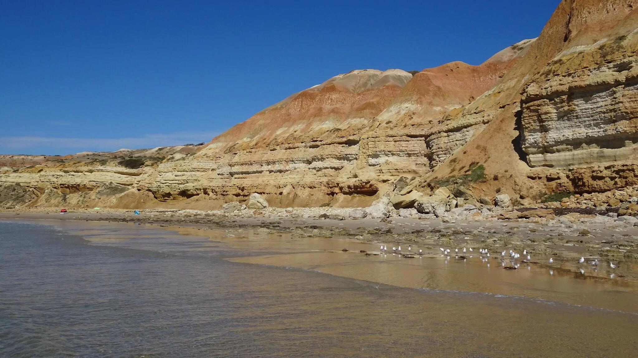 Giant rock cliffs make an epic backdrop when laying on the beach