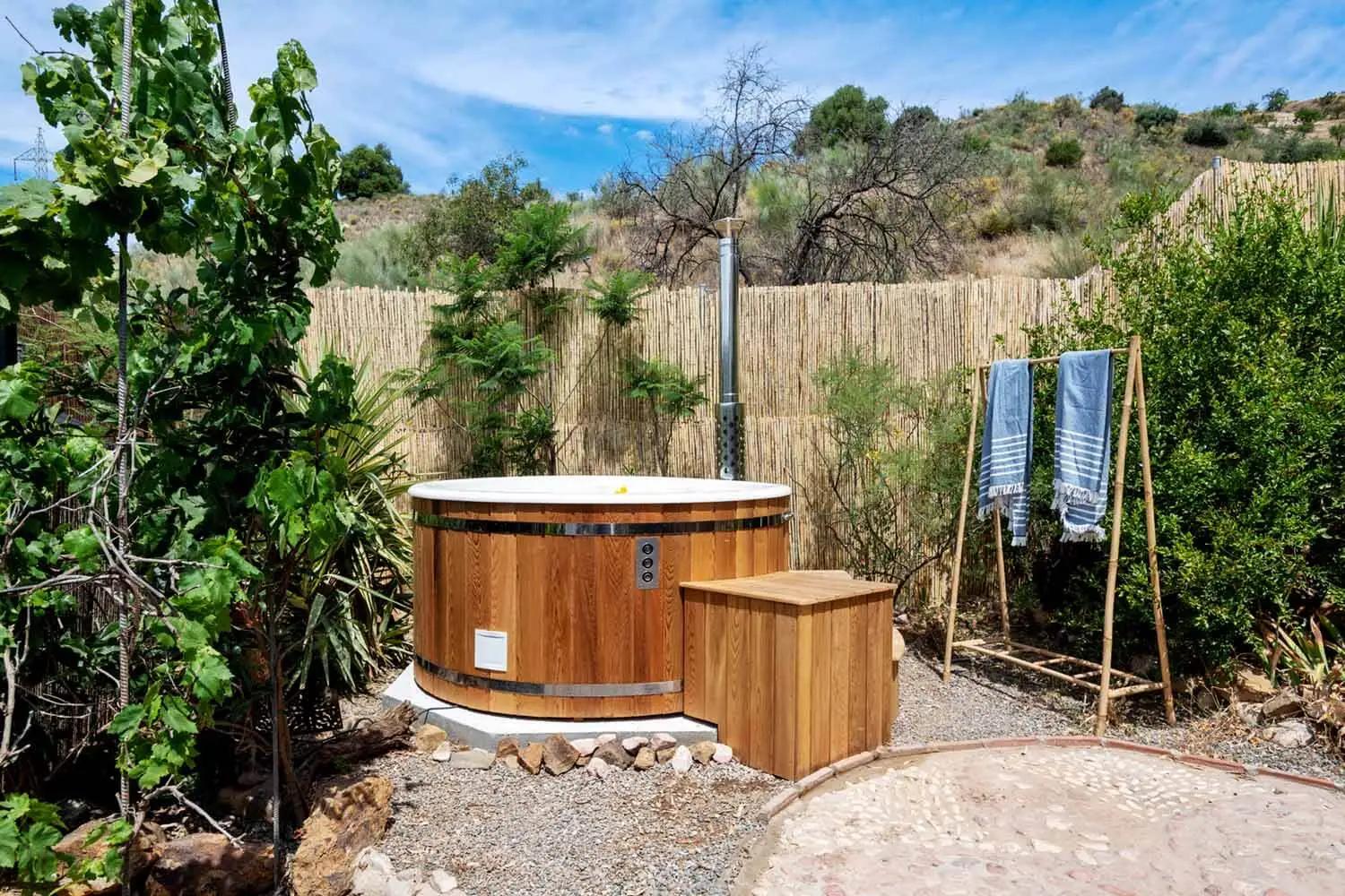 Garden area with wood fired sauna and hot tub at Finca Fabulosa Nudist Resort