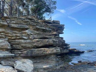 Climb up the rocky ledge (to the left) to access the naturist part at Plage du Liouquet. Caution needed!
