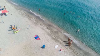 Soft sand and crystal clear water at Domaine Naturiste de Riva Bella