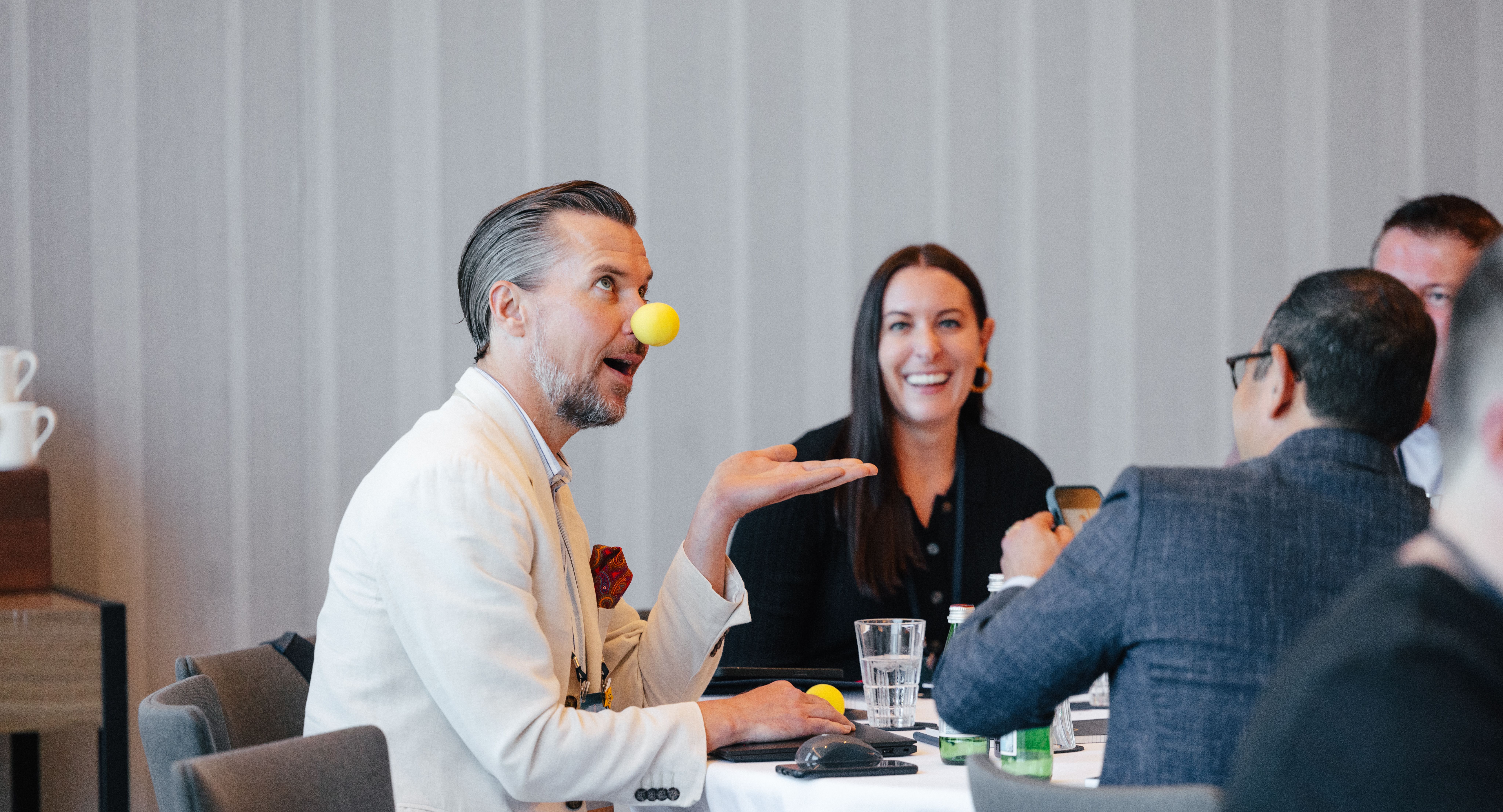 The Summit Nashville attendees at their table with clown noses