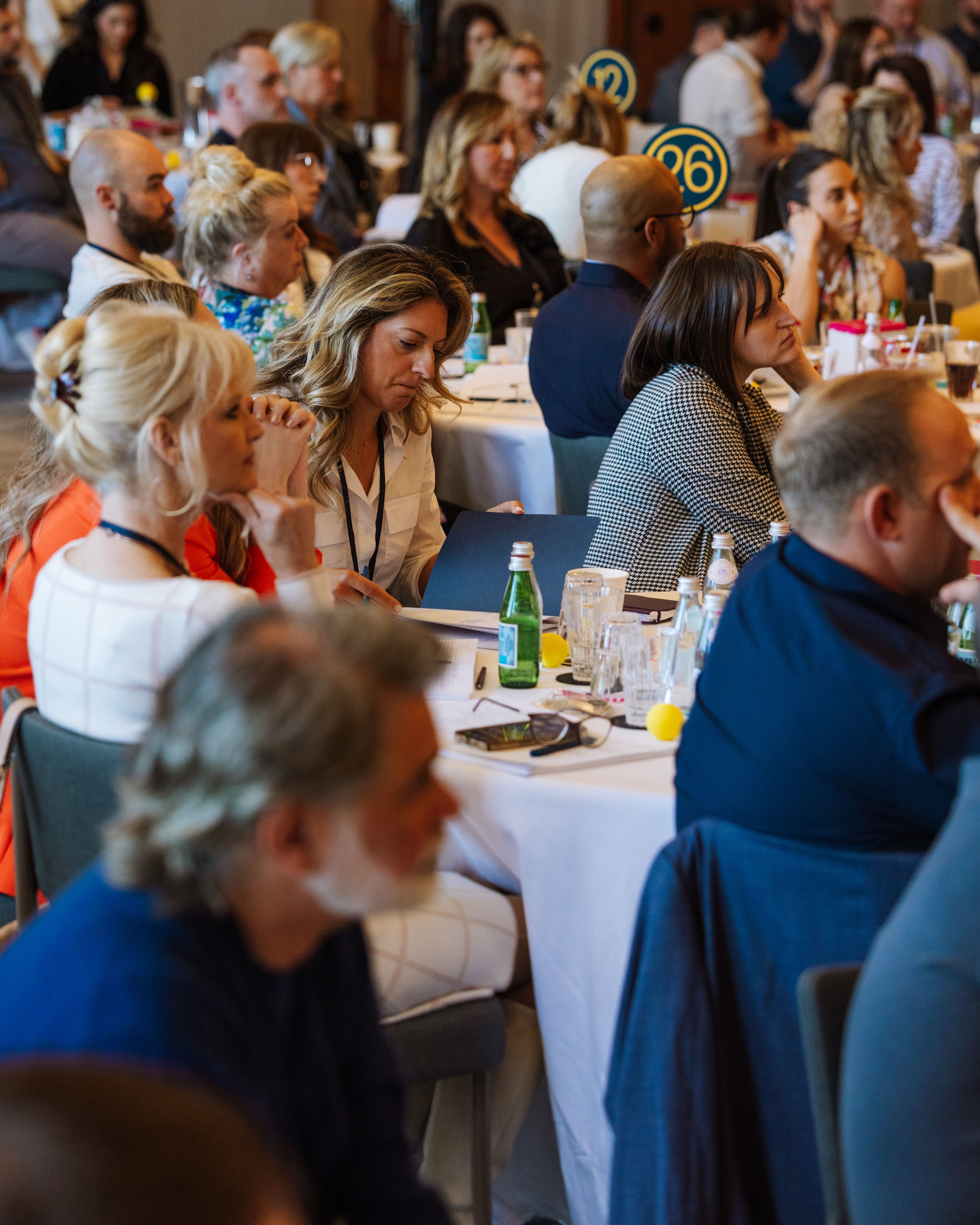 The Summit attendees at tables
